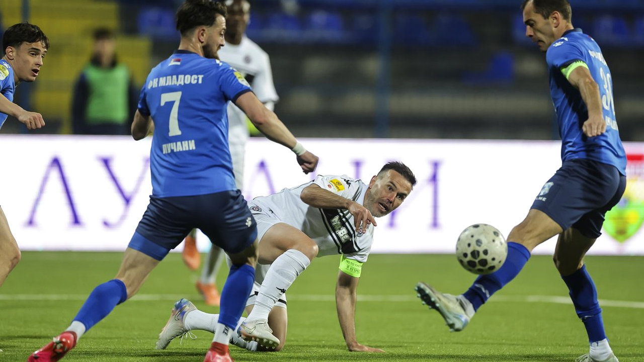 Partizan footballers challenging for the ball in a domestic match