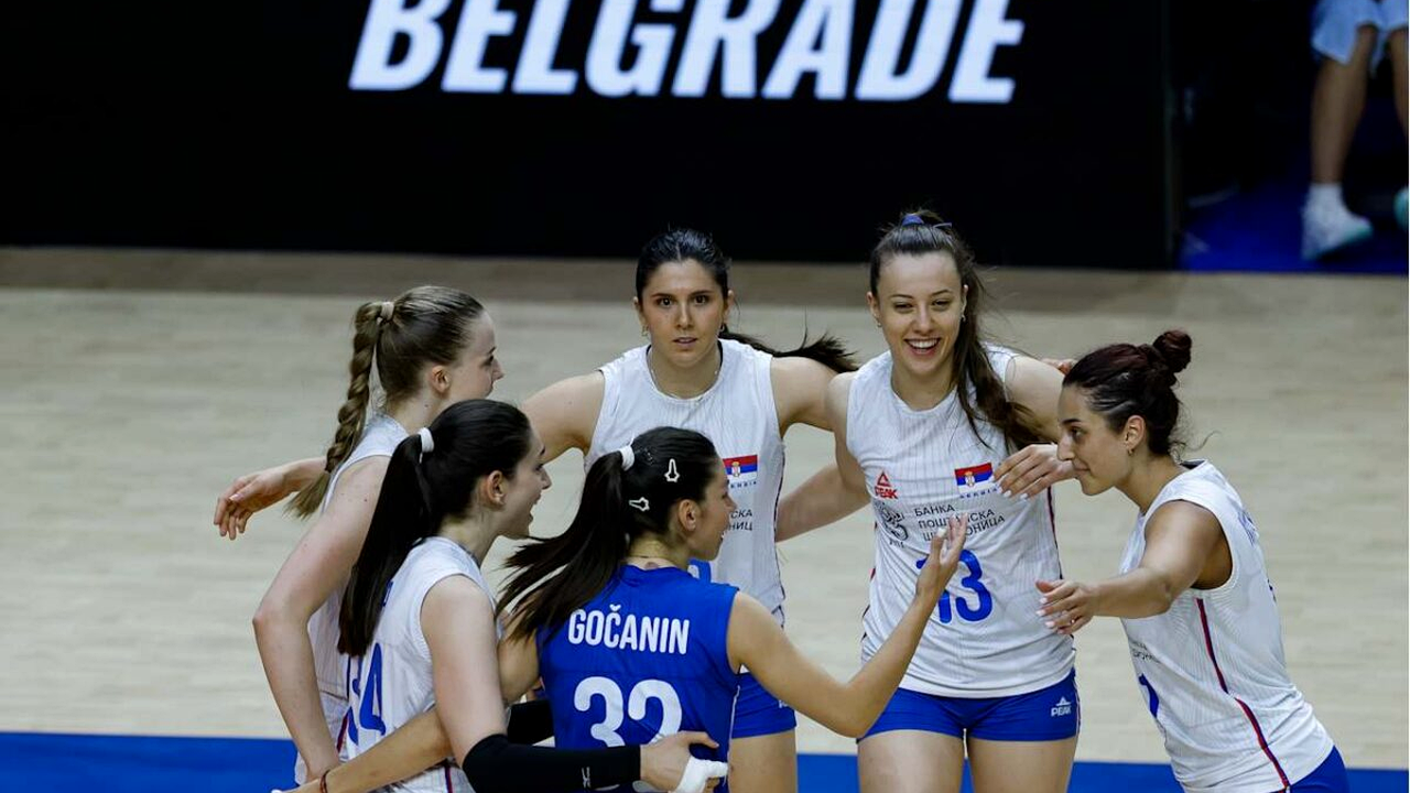 Serbia and Germany volleyball players at the net during Nations League play