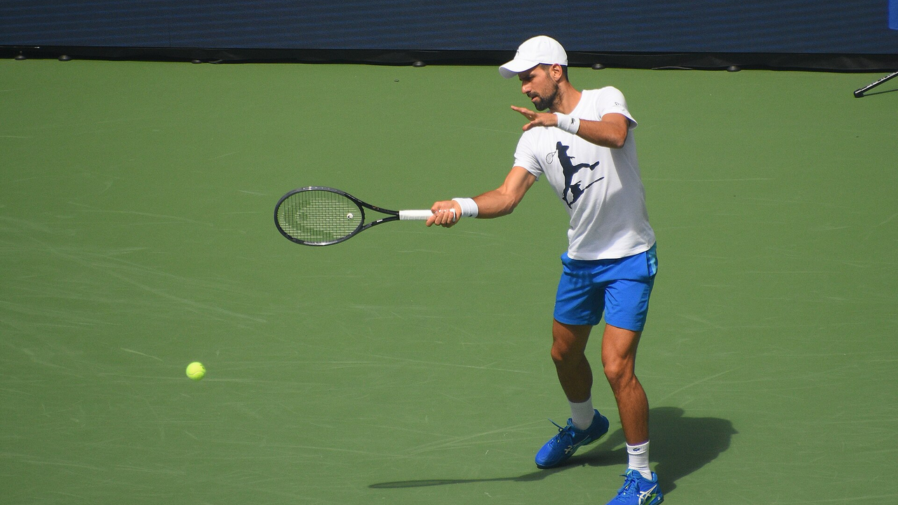 Novak Djokovic practises a forehand on a hard court before the US Open