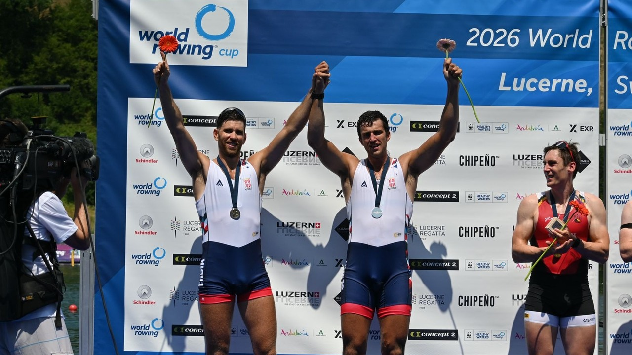 Martin Mackovic and Nikolaj Pimenov celebrate on a rowing podium