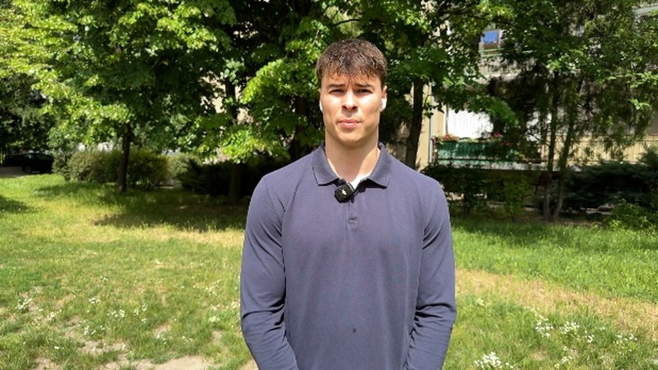 Serbian swimmer Andrej Barna stands outdoors during an interview