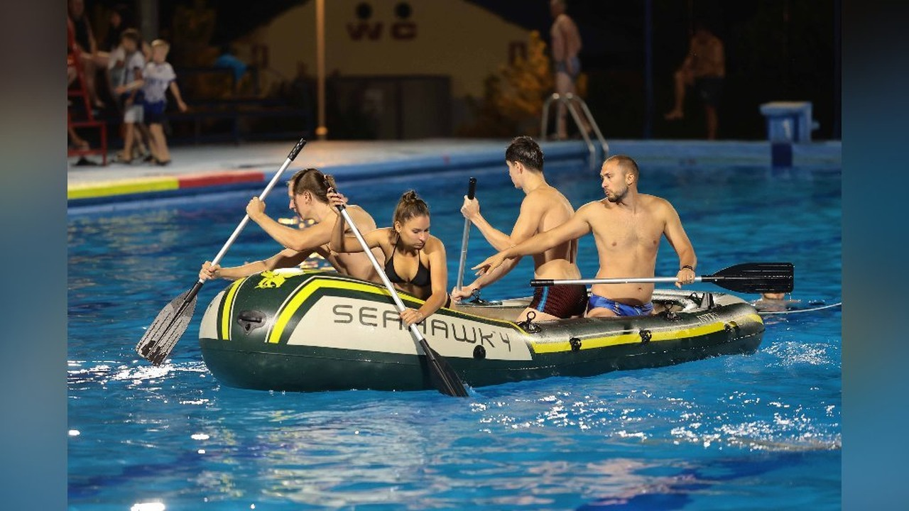 Four competitors paddle an inflatable boat during the Subotica Water Challenge