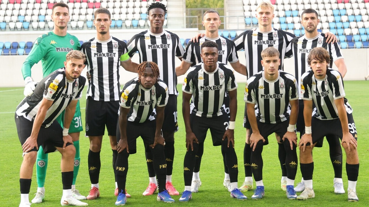 Partizan players pose together before a match