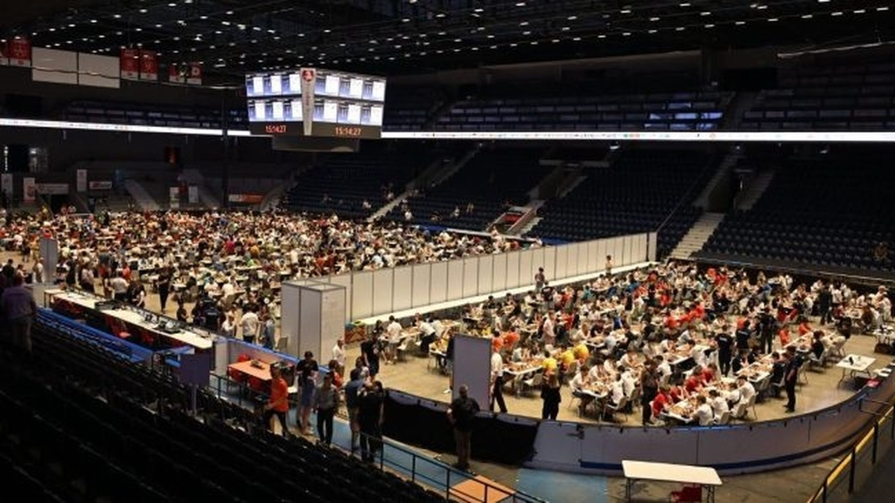Young chess players compete in a large tournament hall