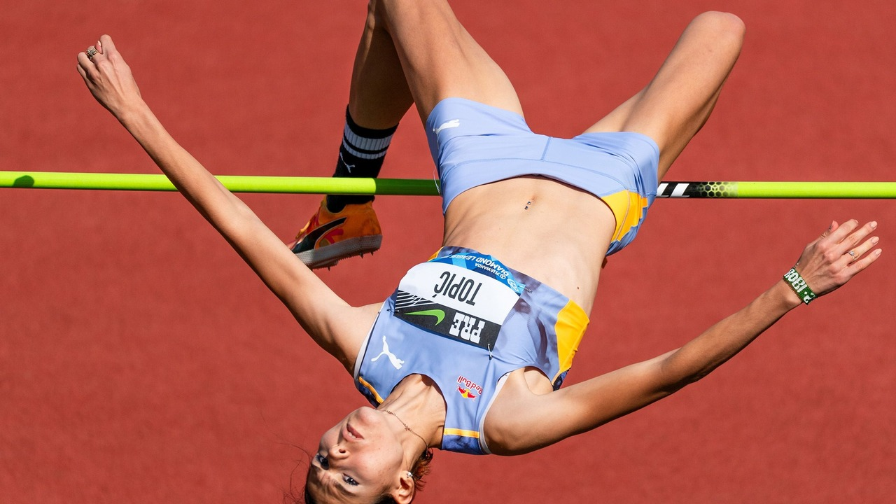 Angelina Topic passes over the bar during a high jump
