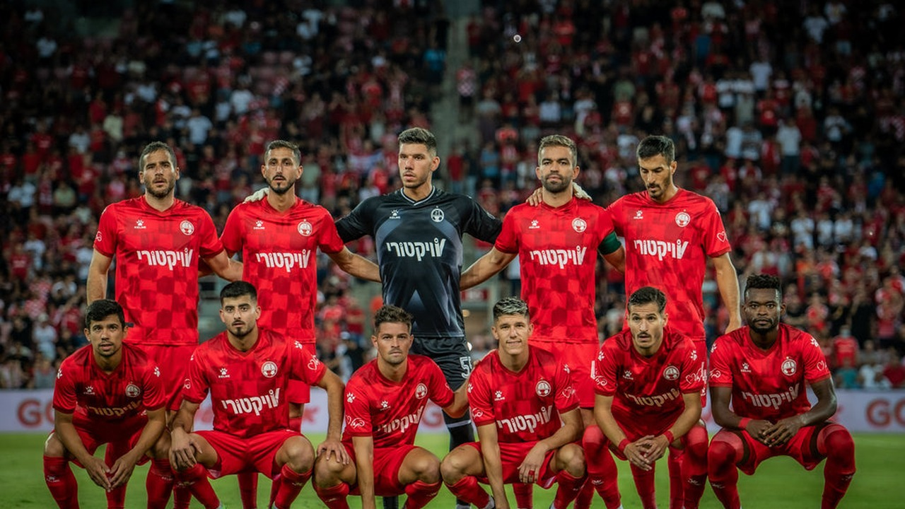 Hapoel Beer-Sheva players pose before a match