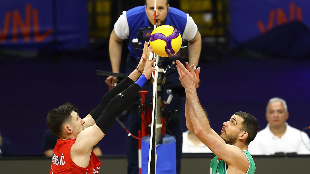 Serbia and Bulgaria players contest the ball at the net