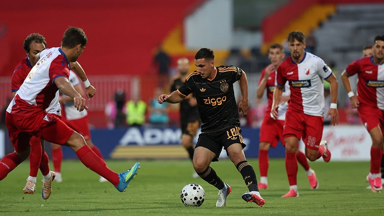 Vojvodina and Ajax players contest the ball during a match