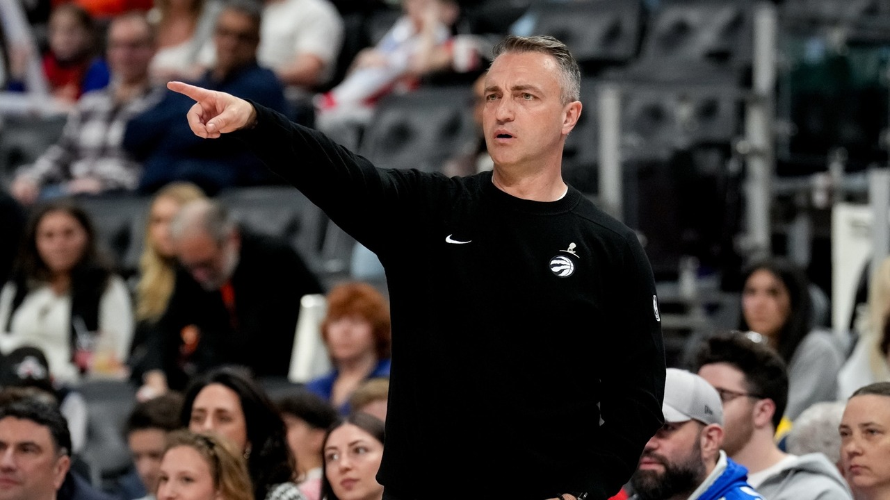 Darko Rajakovic points while coaching during an NBA game