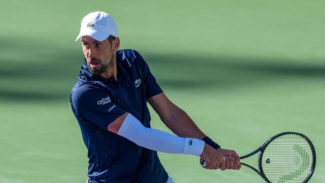 Novak Djokovic hits a two-handed backhand on a hard court