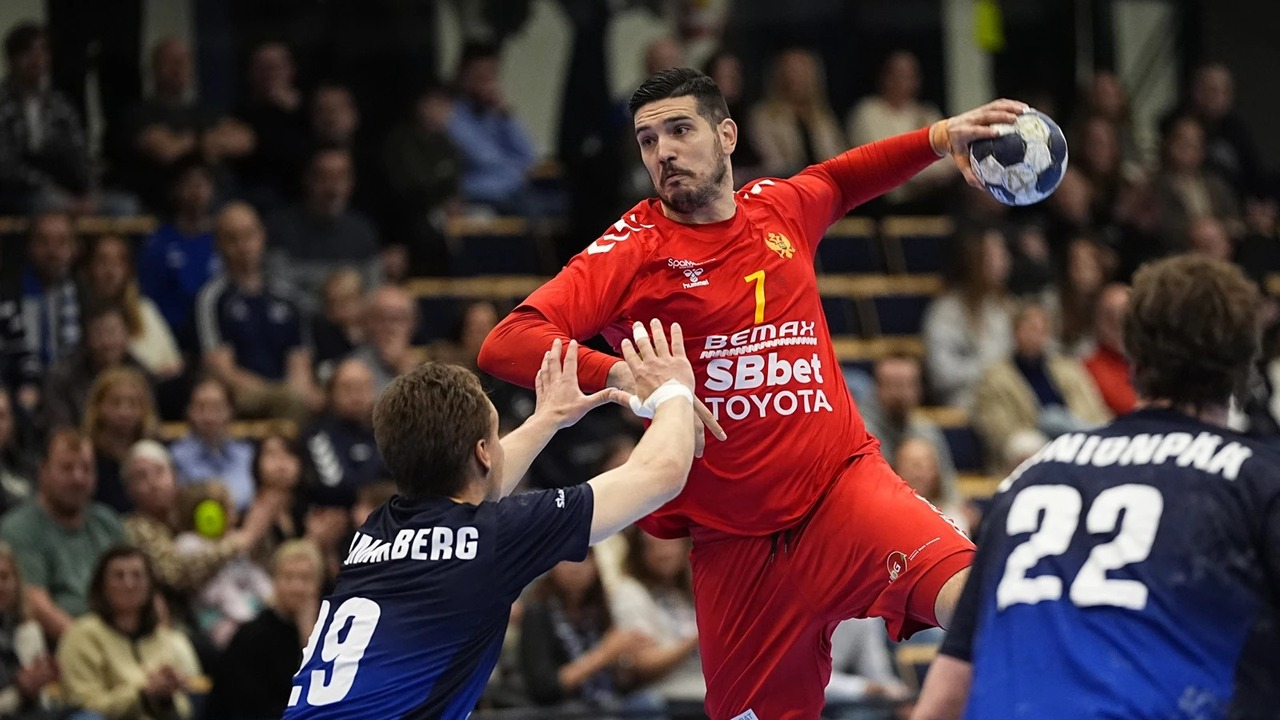 A Serbia handball player jumps to shoot against Lithuania