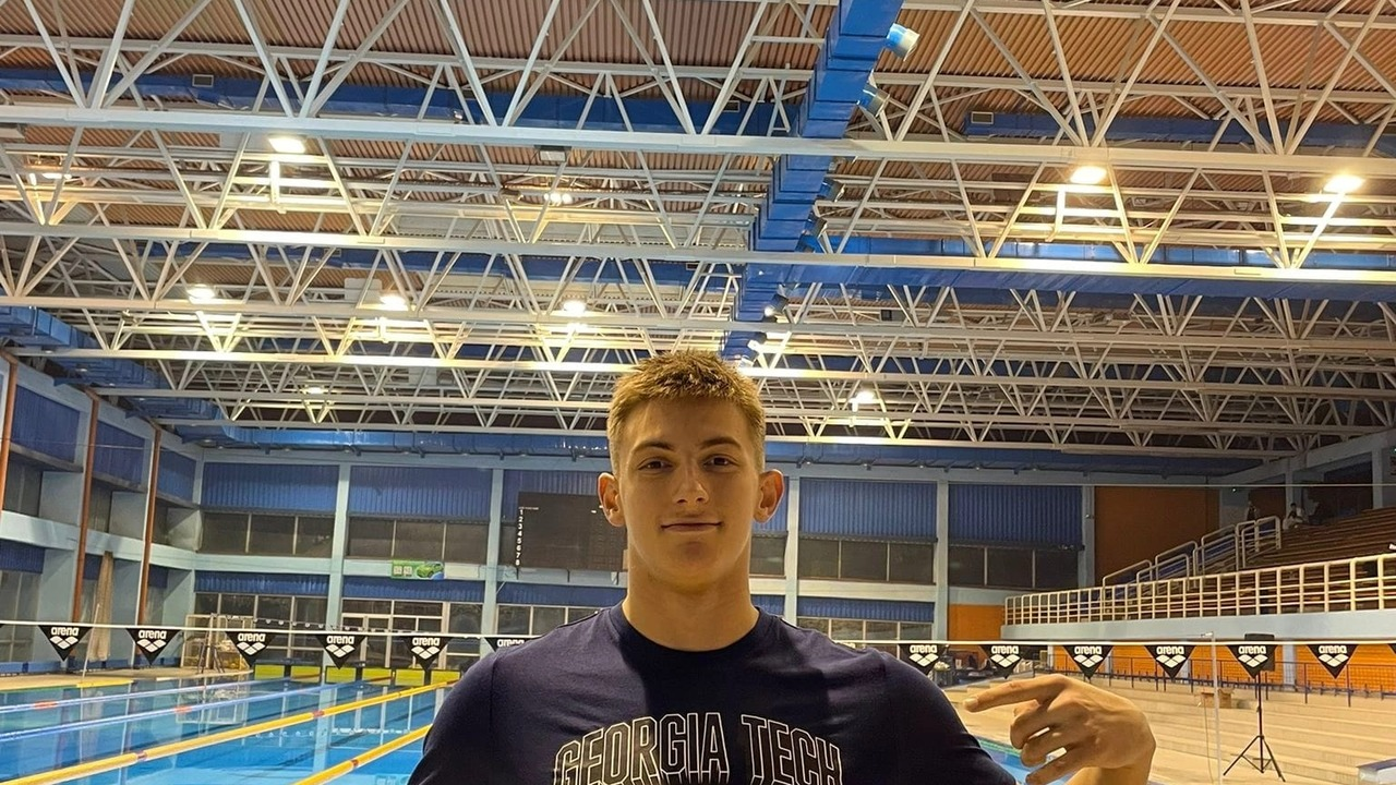 Uroš Živanović stands at a swimming venue