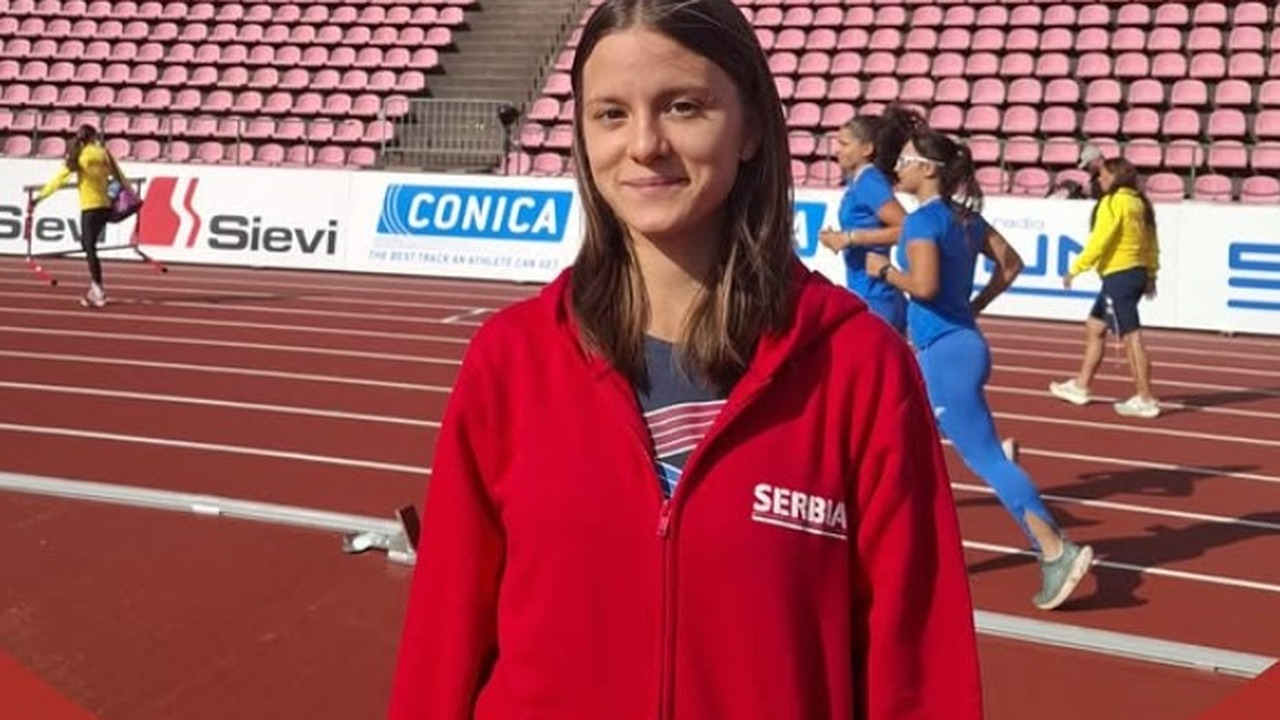 Mina Stankovic stands beside an athletics track