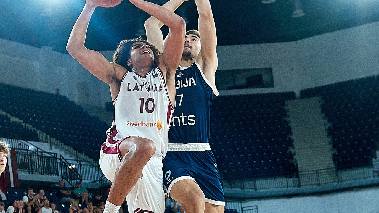 A Serbia under-16 basketball player contests a shot