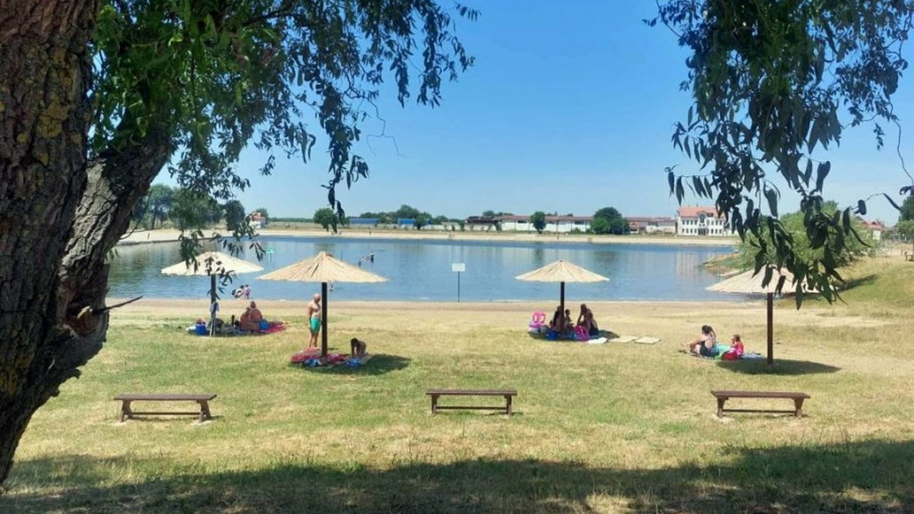 People walk beside the city lake in Vršac