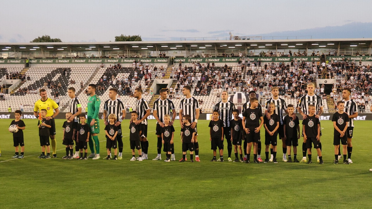 Partizan players stand together before a home match