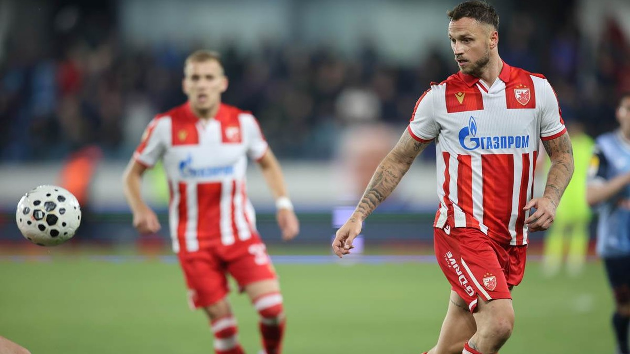 Two Red Star Belgrade players run in red and white shirts