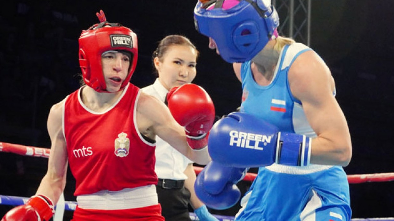 Two women boxers compete in an international ring