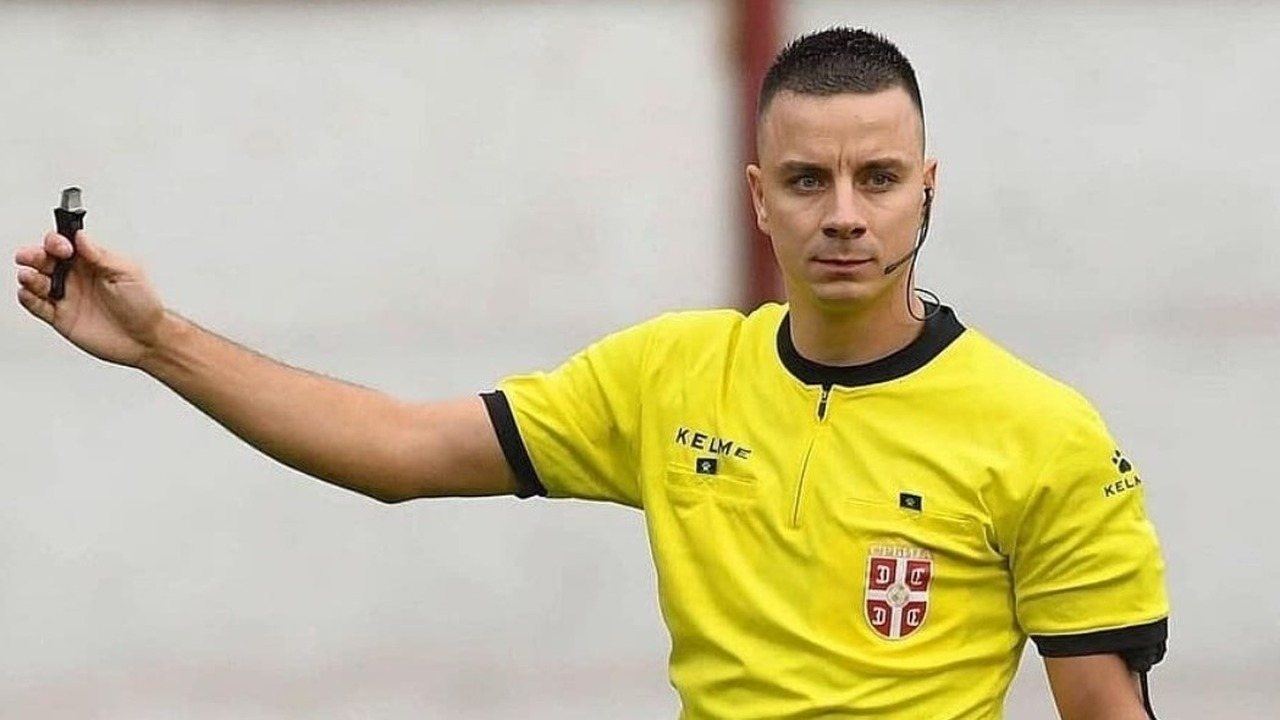 Milos Milanovic signals during a football match