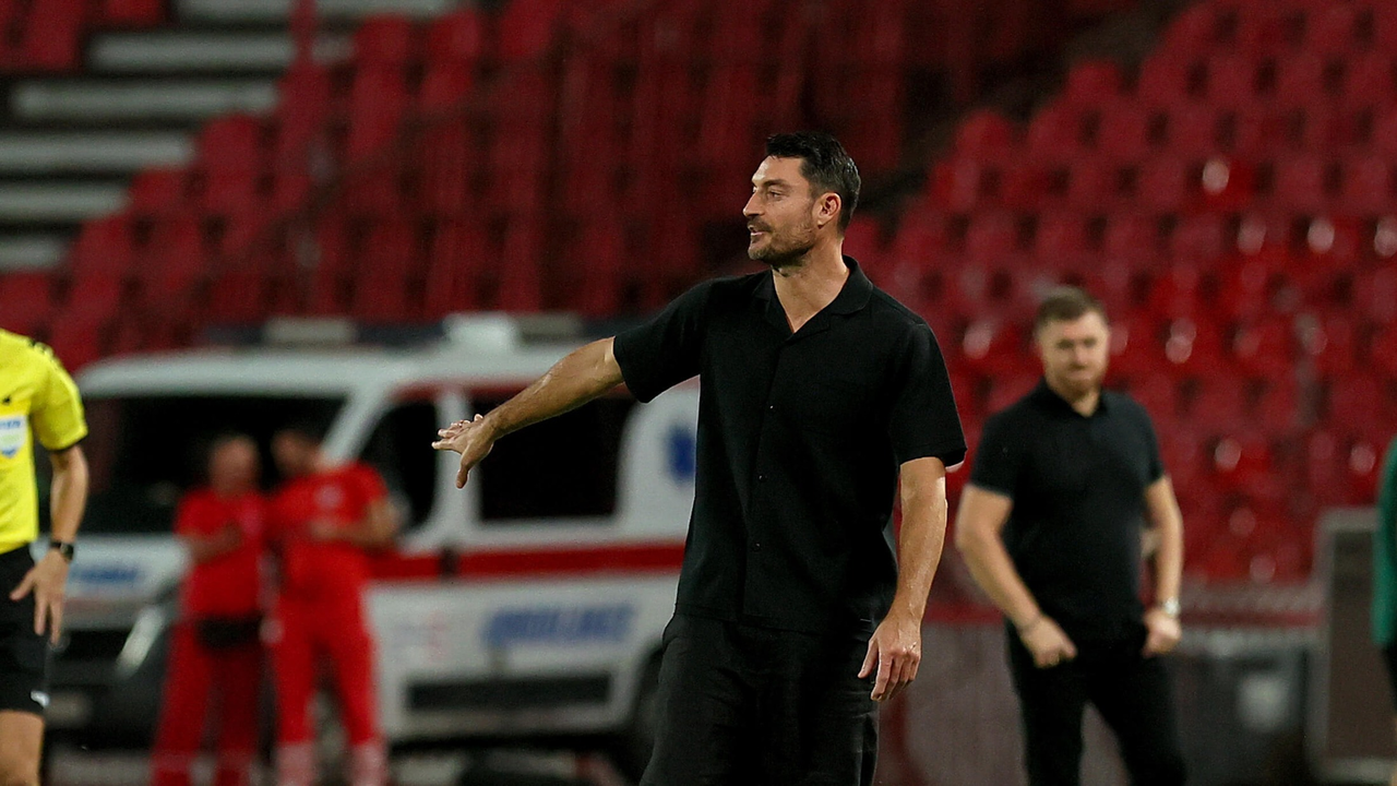 The Red Star coach gives instructions beside the pitch