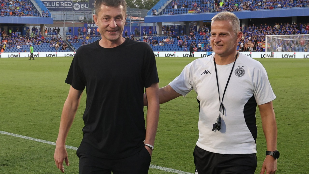 Members of the Partizan coaching staff stand on the pitch in Getafe