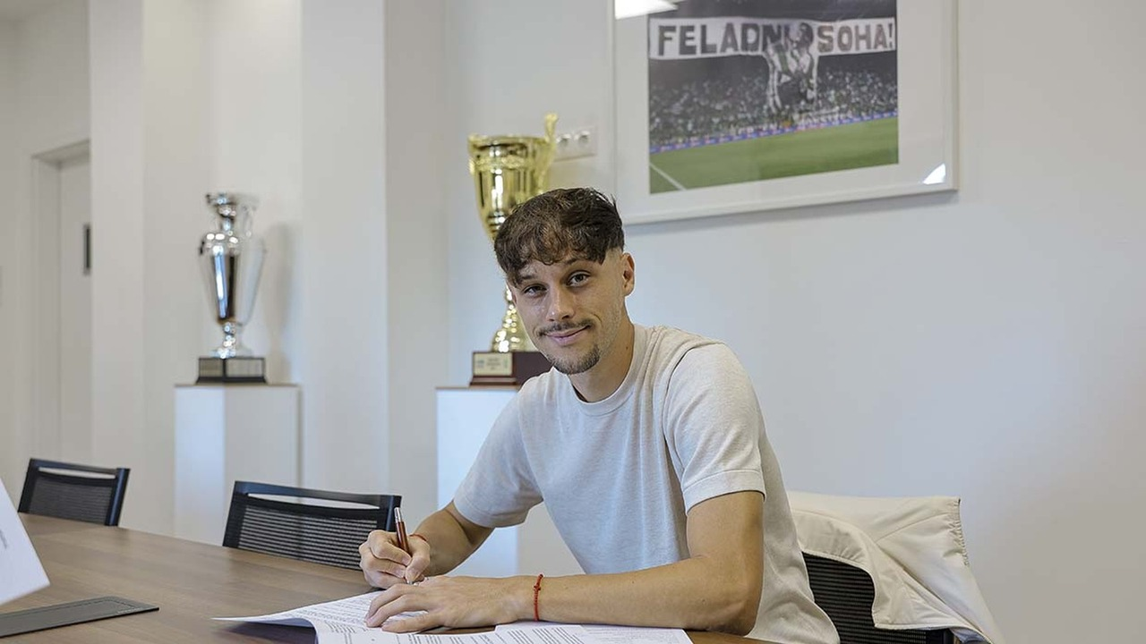 Veljko Birmancevic signs his contract at a club office