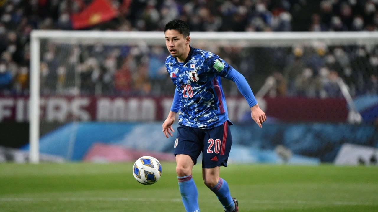 Yuta Nakayama carries the ball for Japan during a match