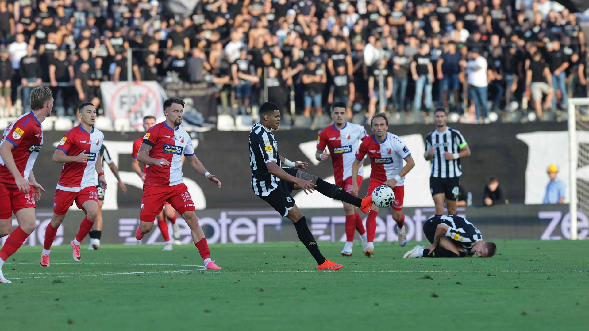 Partizan and Vojvodina players contest the ball during their league match