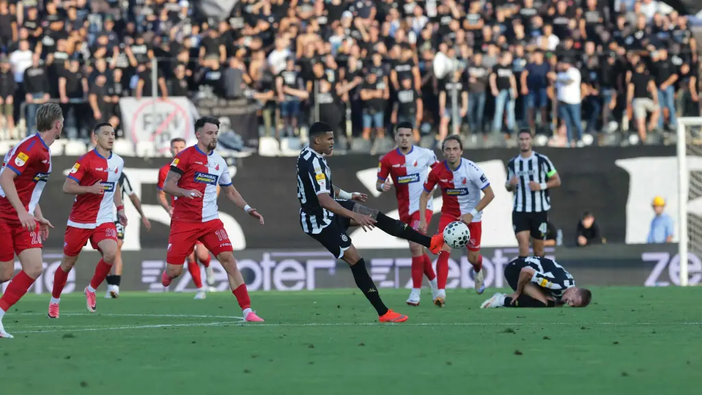 Partizan and Vojvodina players contest the ball during their league match